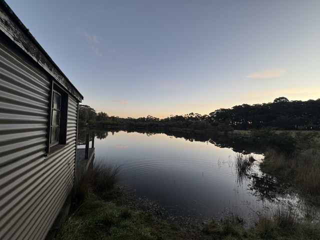 Private dam with a timber jetty room and row boat